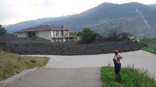 Mudslide barrels through Swiss town [upl. by Bertasi592]