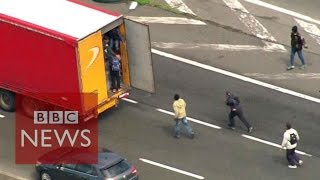 Moment Calais migrants jumped onboard lorries  BBC News [upl. by Foulk]